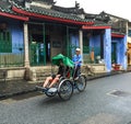 People riding cyclos on main road at Ancient town in Hoi an, Vietnam